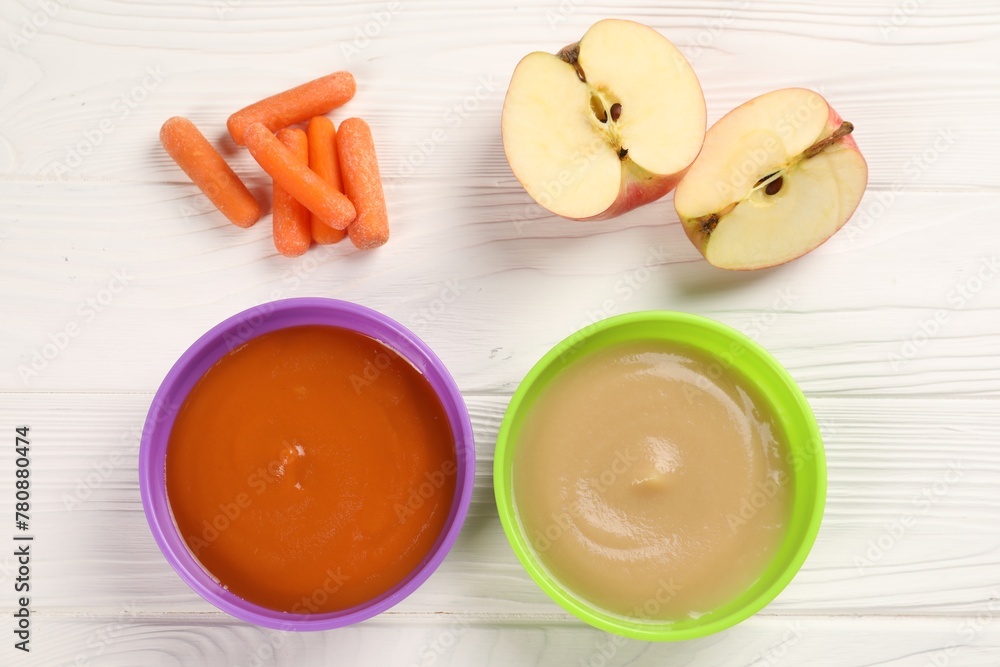 Baby food. Purees of apples and carrots in bowls on white wooden table, flat lay Baby food. Purees of apples and carrots in bowls on white wooden table, flat lay