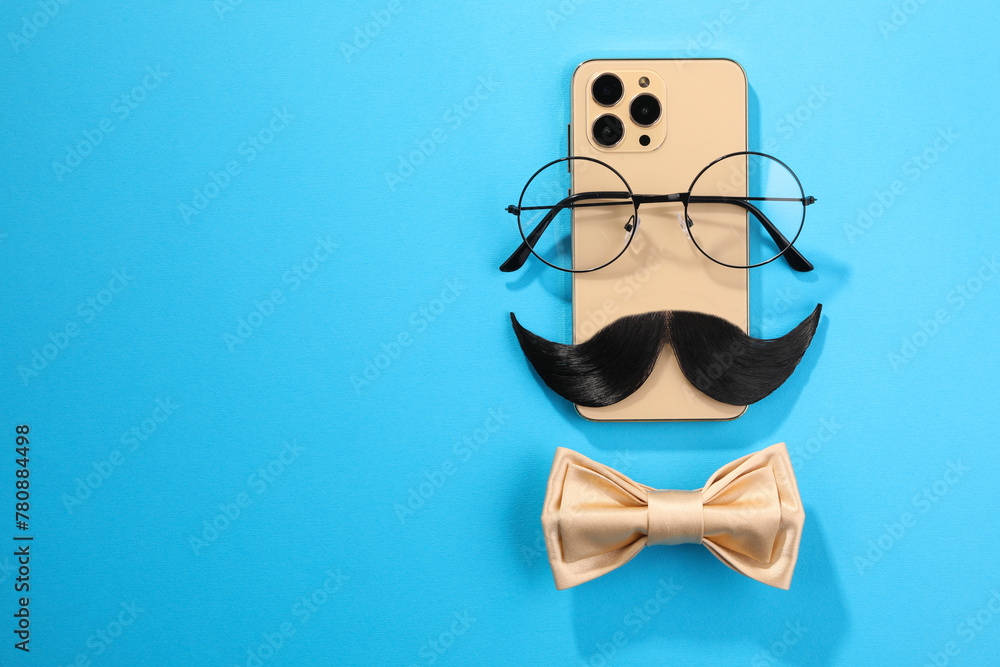 Flat lay composition with artificial moustache and glasses on light blue background, space for text Flat lay composition with artificial moustache and glasses on light blue background, space for text
