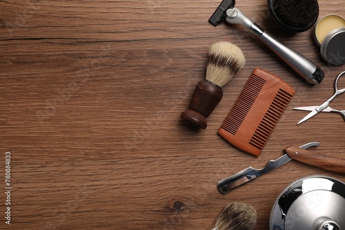 Moustache and beard styling tools on wooden background, flat lay. Space for text © New Africa