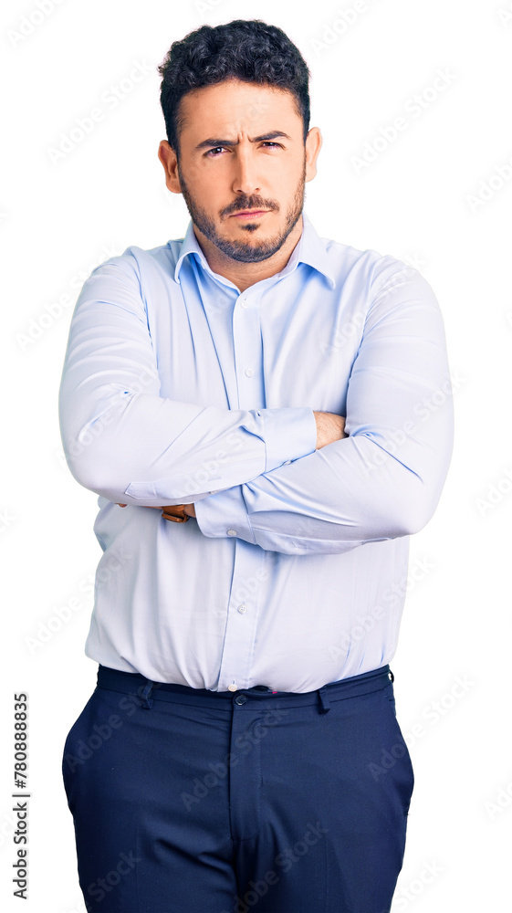 Young hispanic man wearing business clothes skeptic and nervous, disapproving expression on face with crossed arms. negative person. Young hispanic man wearing business clothes skeptic and nervous, disapproving expression on face with crossed arms. negative person.