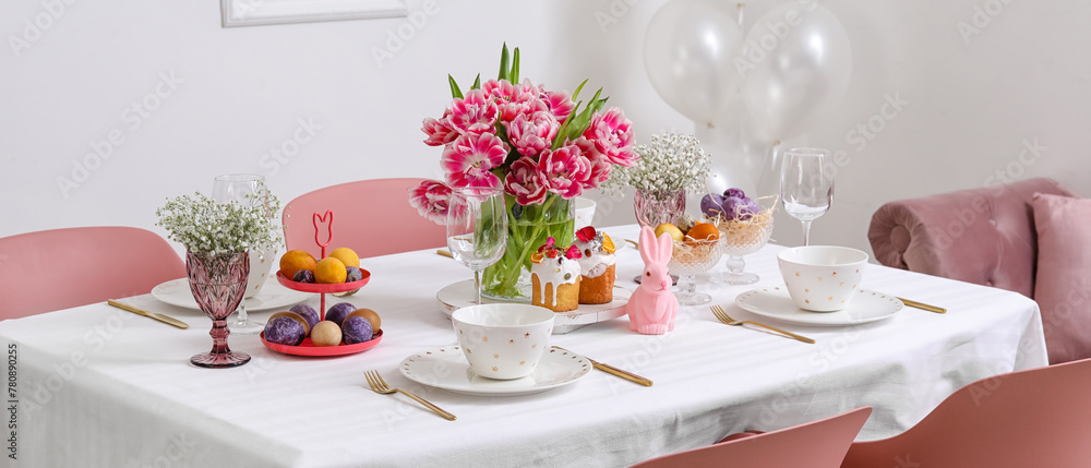 Fototapeta premium Stylish table setting with beautiful tulips for Easter celebration in room
