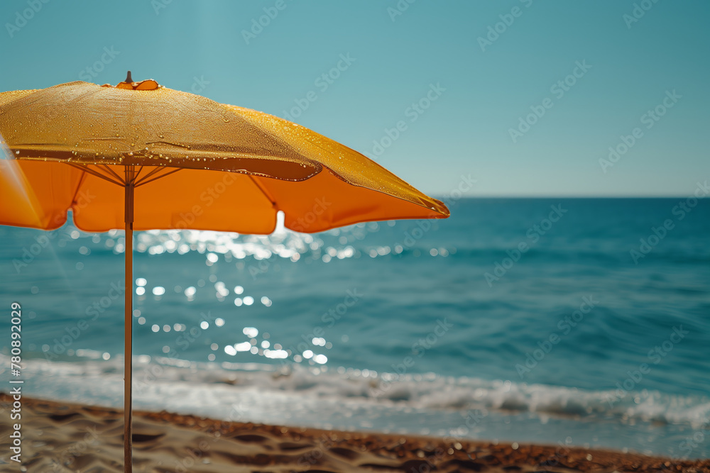 Orange beach umbrella with sea in the background