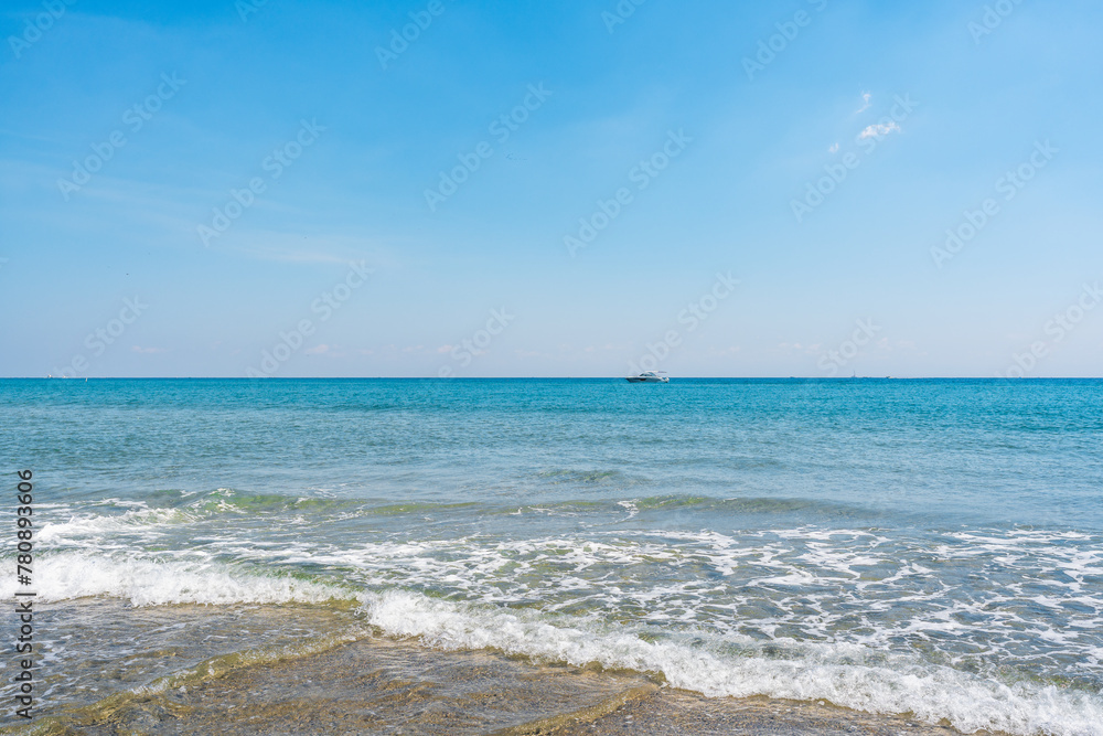 boat in ocean with blue sky and copy space