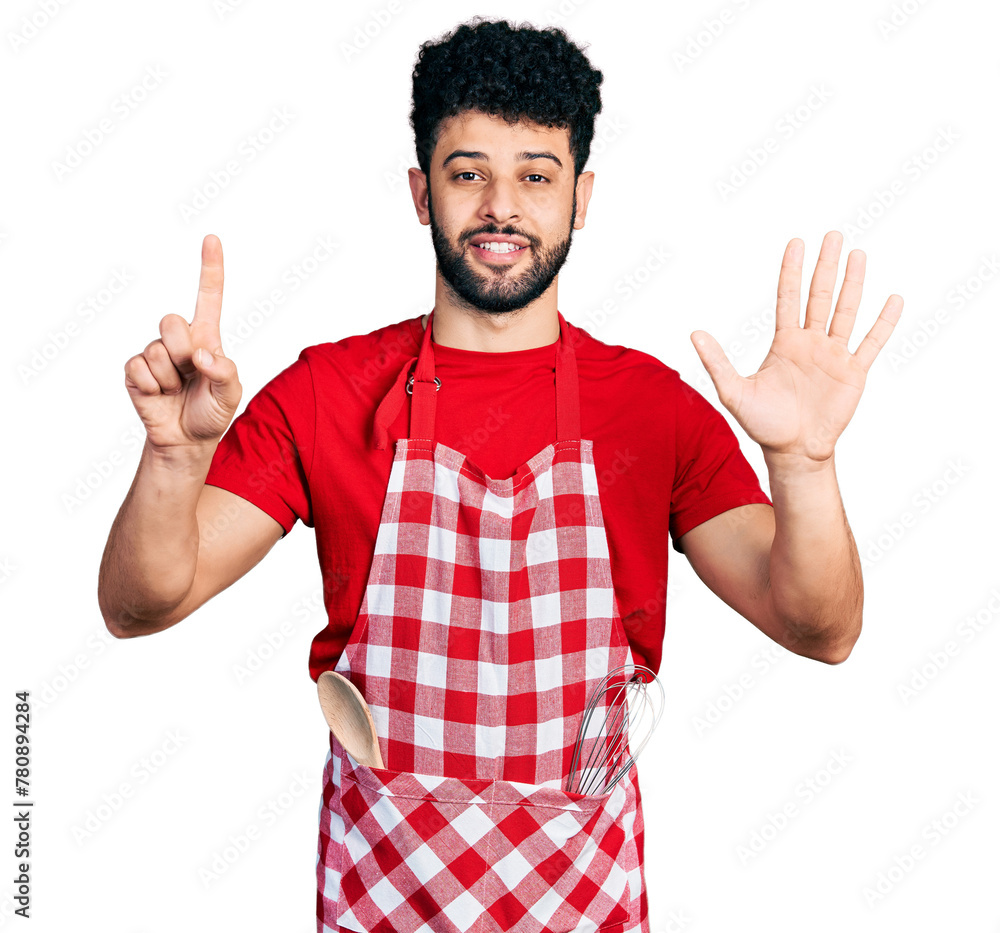 Young arab man with beard wearing cook apron showing and pointing up with fingers number six while smiling confident and happy. Young arab man with beard wearing cook apron showing and pointing up with fingers number six while smiling confident and happy.