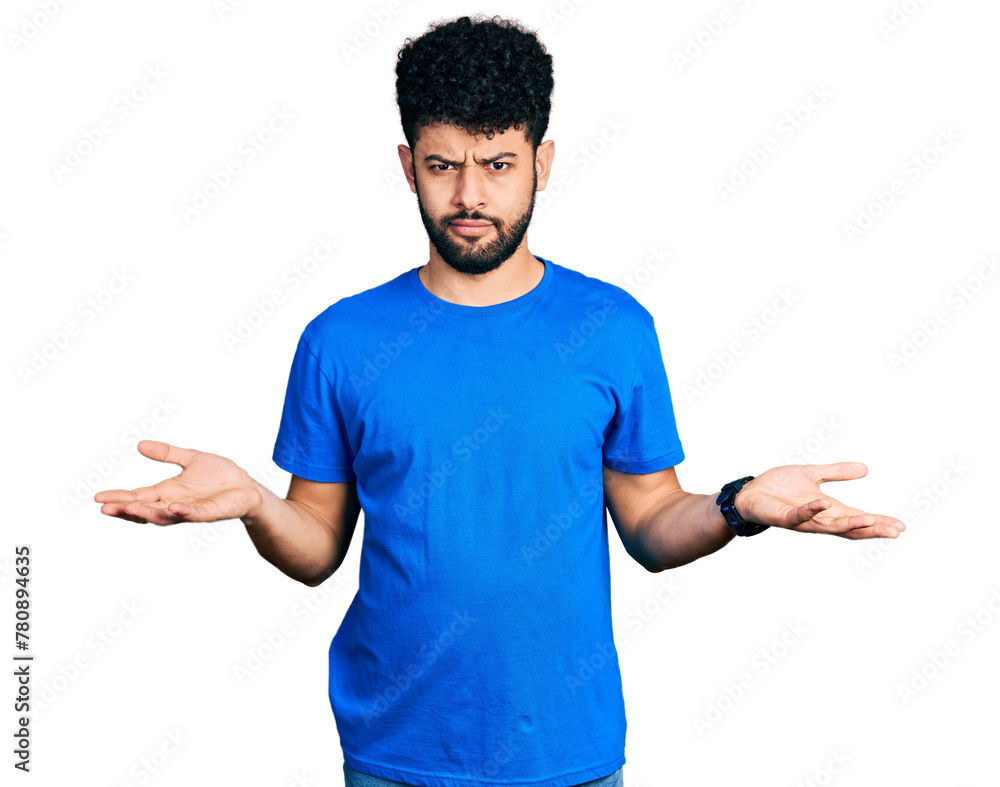 Young arab man with beard wearing casual blue t shirt clueless and confused with open arms, no idea concept. Young arab man with beard wearing casual blue t shirt clueless and confused with open arms, no idea concept.