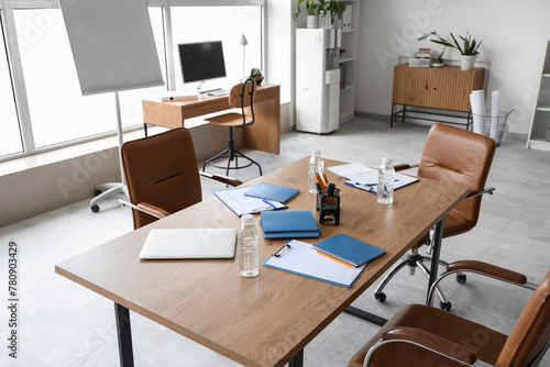 Table and stationery prepared for business meeting in conference hall © Pixel-Shot