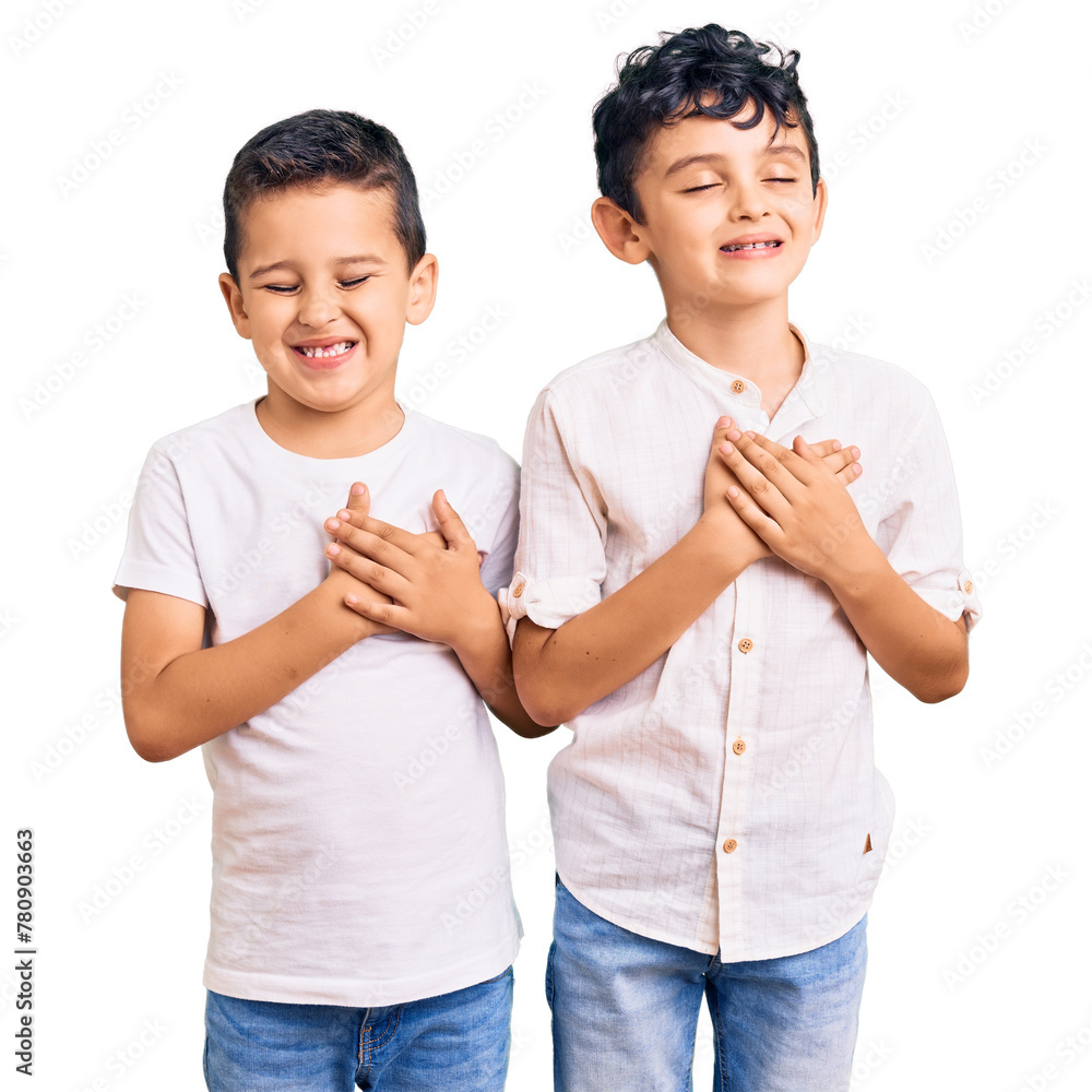 Couple of little brothers together wearing casual clothes smiling with hands on chest with closed eyes and grateful gesture on face. health concept.