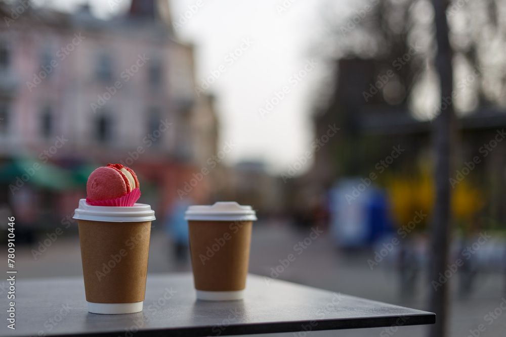 take away coffee with macaron on the street