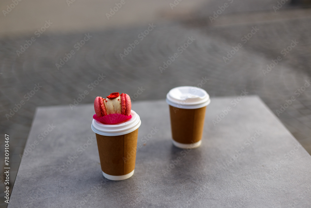 take away coffee with macaron on the street