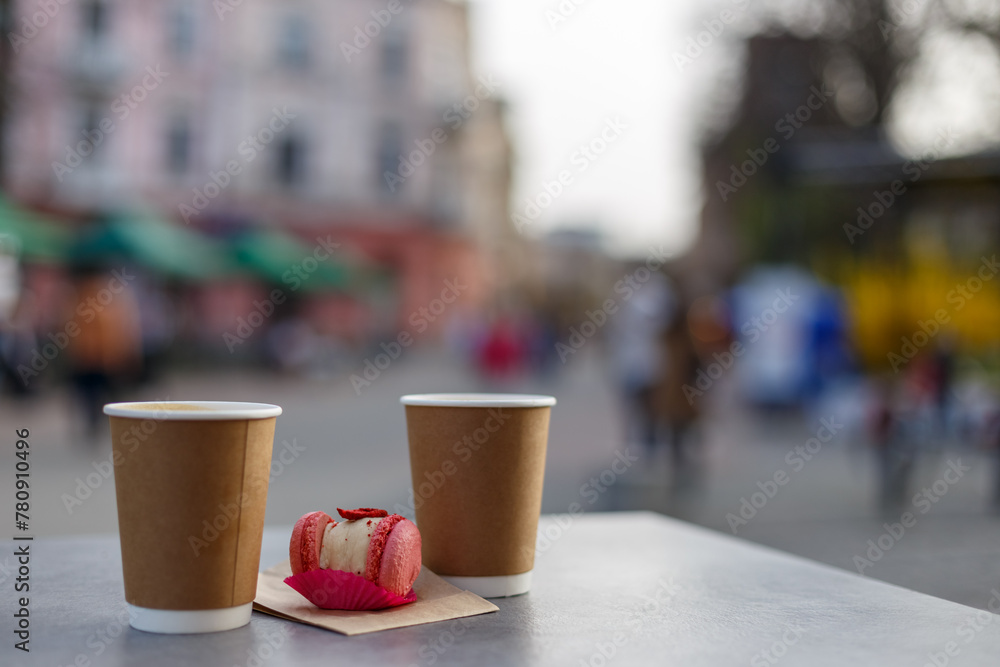 take away coffee with macaron on the street