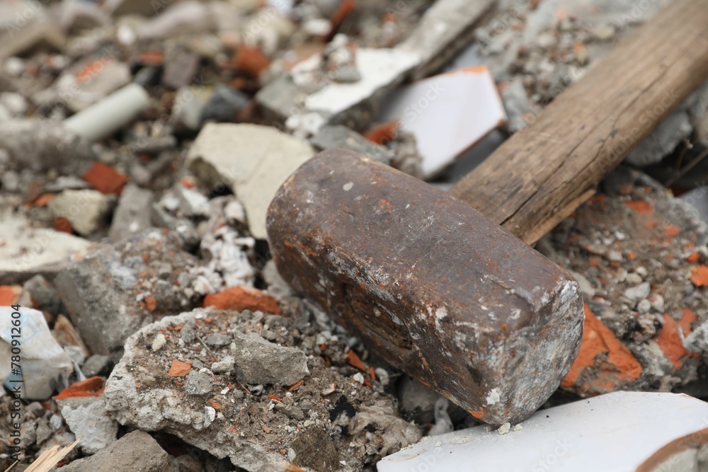 Sledgehammer on pile of broken bricks, closeup Sledgehammer on pile of broken bricks, closeup