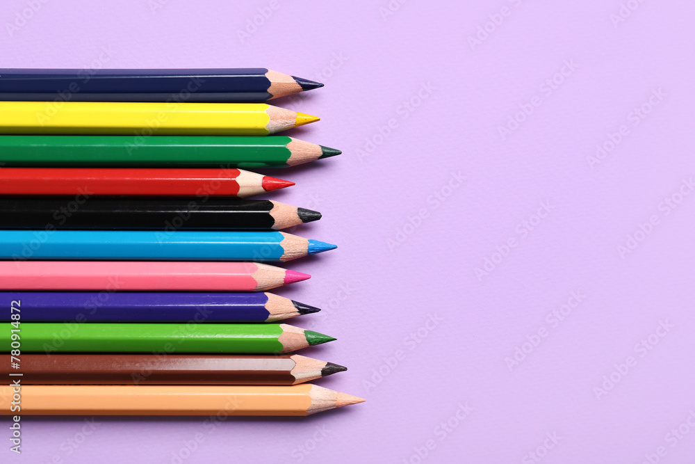 Set of color pencils on purple background, closeup Set of color pencils on purple background, closeup
