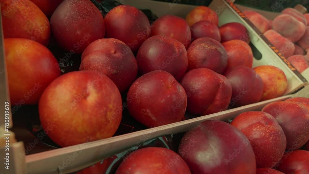 Fresh organic peaches stand at a farmers market close up. A selection of fruit from local producers and seasonal products Fresh organic peaches stand at a farmers market close up. A selection of fruit from local producers and seasonal products