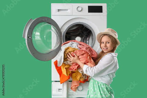 Little girl doing laundry o...