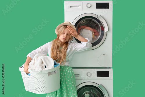 Tired little girl with laun...