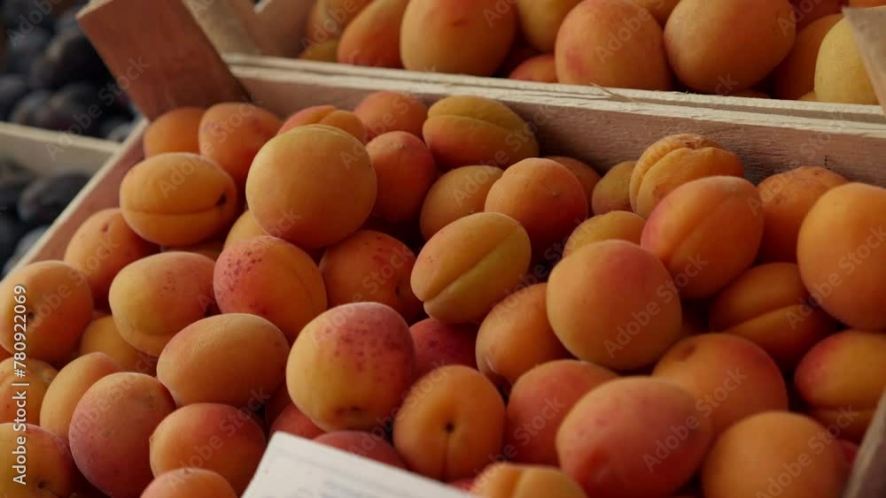 Fresh organic peaches stand at a farmers market close up. A selection of fruit from local producers and seasonal products Fresh organic peaches stand at a farmers market close up. A selection of fruit from local producers and seasonal products