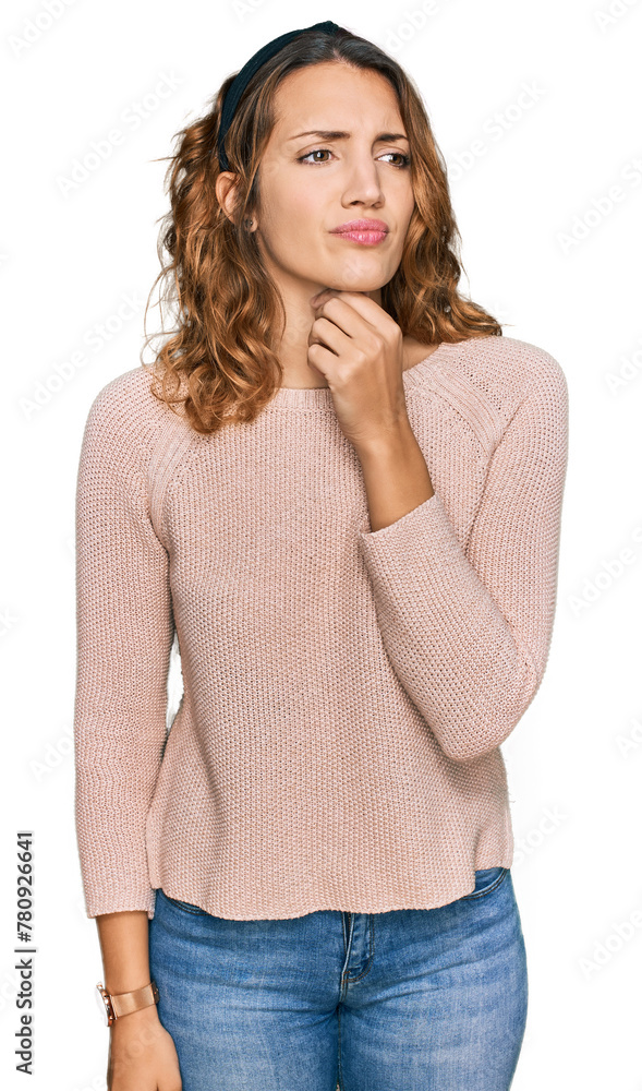 Beautiful young caucasian woman wearing casual sweater touching painful neck, sore throat for flu, clod and infection Beautiful young caucasian woman wearing casual sweater touching painful neck, sore throat for flu, clod and infection