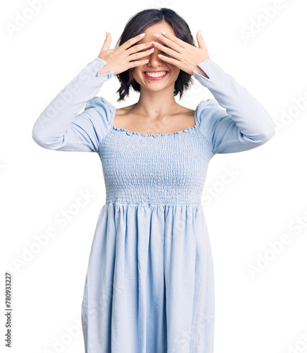 Young beautiful girl wearing casual clothes covering eyes with hands smiling cheerful and funny. blind concept.