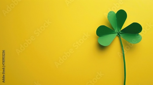 Four leaf clover symbol on bright yellow backdrop, suitable for luck and positivity concepts