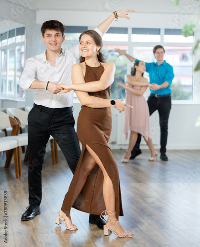 Guy is professional dancer and teacher focused on his female partner, teaching her to perform incendiary tango during off-site workshop.