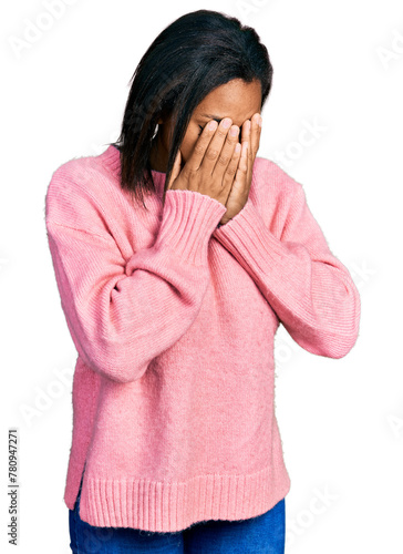 Beautiful hispanic woman wearing casual winter sweater with sad expression covering face with hands while crying. depression concept.