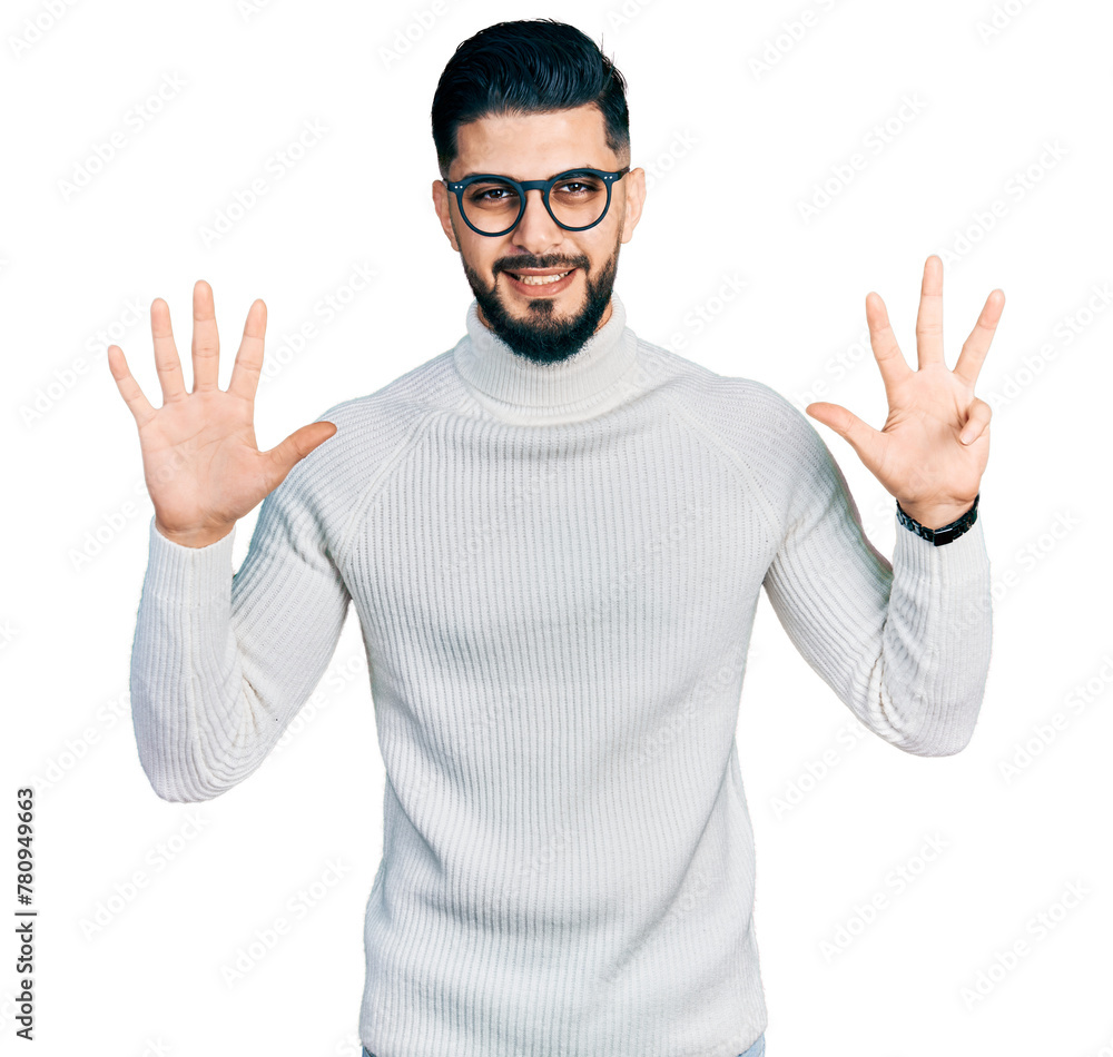 Naklejka premium Young arab man with beard wearing elegant turtleneck sweater and glasses showing and pointing up with fingers number nine while smiling confident and happy.