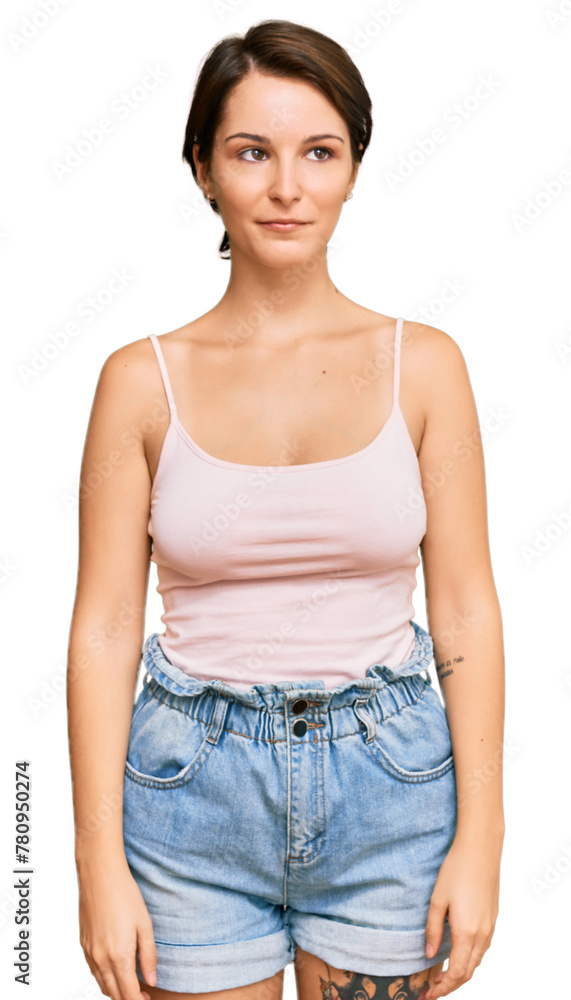 Young brunette woman with short hair wearing casual summer clothes with serious expression on face. simple and natural looking at the camera. Young brunette woman with short hair wearing casual summer clothes with serious expression on face. simple and natural looking at the camera.