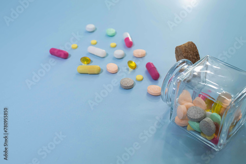 Close up of teblets pills spilling from Plastic pill photo
