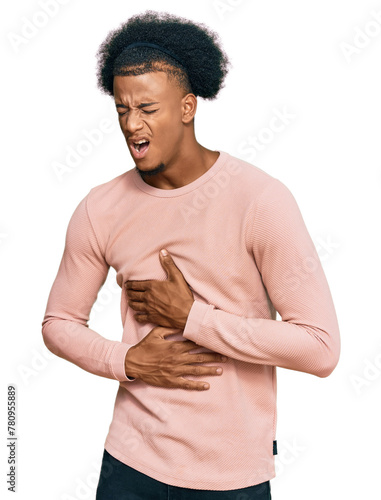 African american man with afro hair wearing casual clothes with hand on stomach because nausea, painful disease feeling unwell. ache concept.