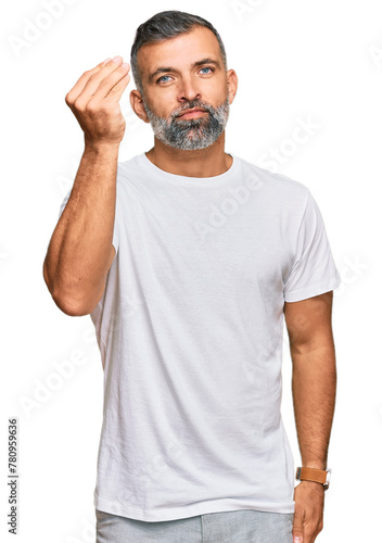 Middle age handsome man wearing casual white tshirt doing italian gesture with hand and fingers confident expression