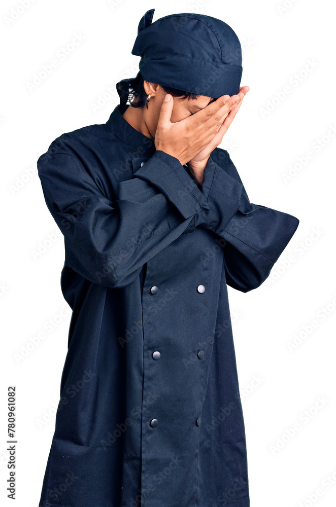 Young brunette woman with short hair wearing professional cook uniform with sad expression covering face with hands while crying. depression concept. Young brunette woman with short hair wearing professional cook uniform with sad expression covering face with hands while crying. depression concept.