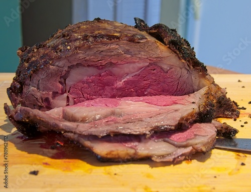 Prime rib roast roasted and sliced to expose medium rare meat