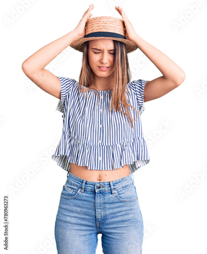 Young beautiful girl wearing hat and t shirt suffering from headache desperate and stressed because pain and migraine. hands on head.