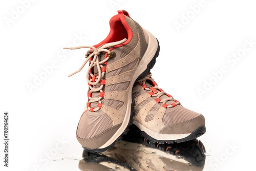 pair brown comfortable New trekking sneakers, waterproof hiking boots with laces on wet mirror with water drops background, modern footwear, natural suede for outdoor hiking, camping © kittyfly