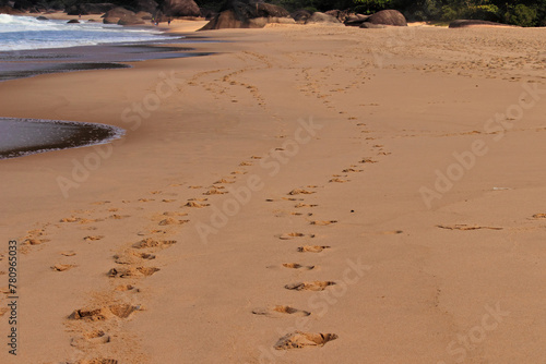 footprints on the beafootprints side by side in the sand of the beach in Trindade.ch
