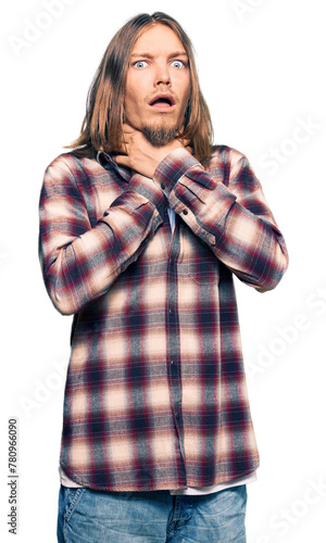 Handsome caucasian man with long hair wearing hipster shirt shouting and suffocate because painful strangle. health problem. asphyxiate and suicide concept.