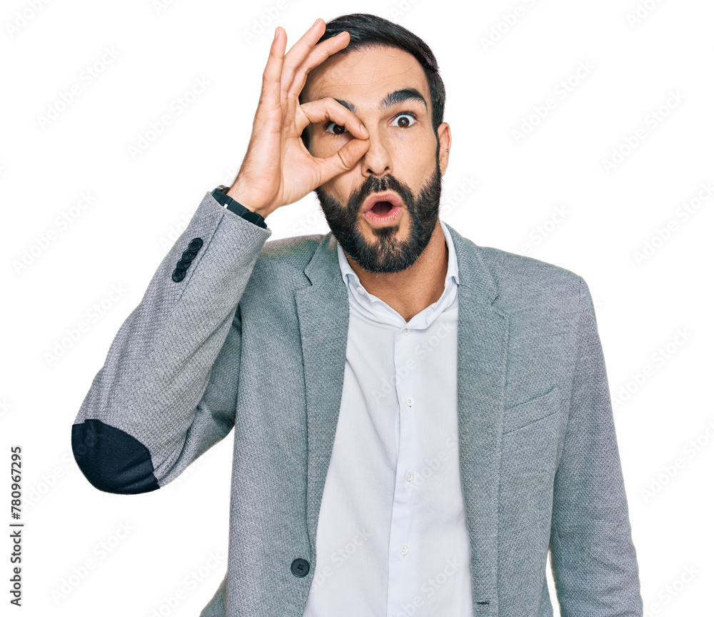 Young hispanic man wearing business clothes doing ok gesture shocked with surprised face, eye looking through fingers. unbelieving expression. Young hispanic man wearing business clothes doing ok gesture shocked with surprised face, eye looking through fingers. unbelieving expression.