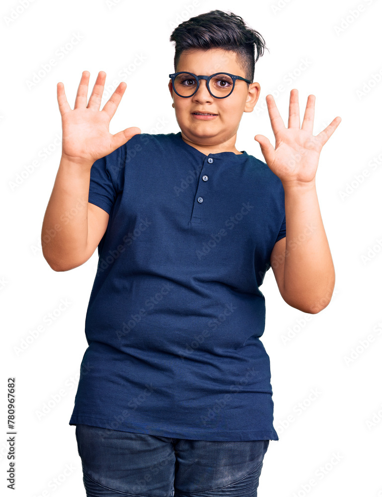 Little boy kid wearing casual clothes and glasses afraid and terrified with fear expression stop gesture with hands, shouting in shock. panic concept. Little boy kid wearing casual clothes and glasses afraid and terrified with fear expression stop gesture with hands, shouting in shock. panic concept.