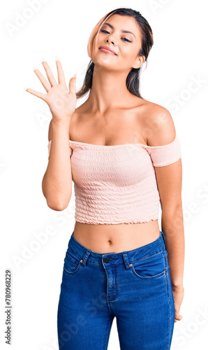 Young beautiful woman wearing casual clothes showing and pointing up with fingers number five while smiling confident and happy.
