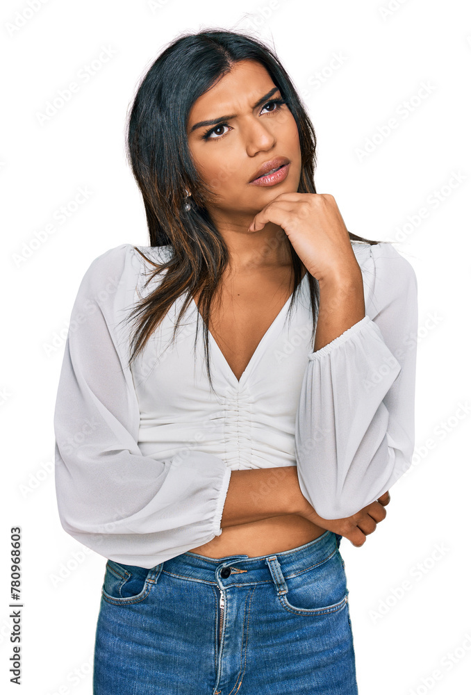 Young latin transsexual transgender woman wearing casual clothes thinking worried about a question, concerned and nervous with hand on chin Young latin transsexual transgender woman wearing casual clothes thinking worried about a question, concerned and nervous with hand on chin
