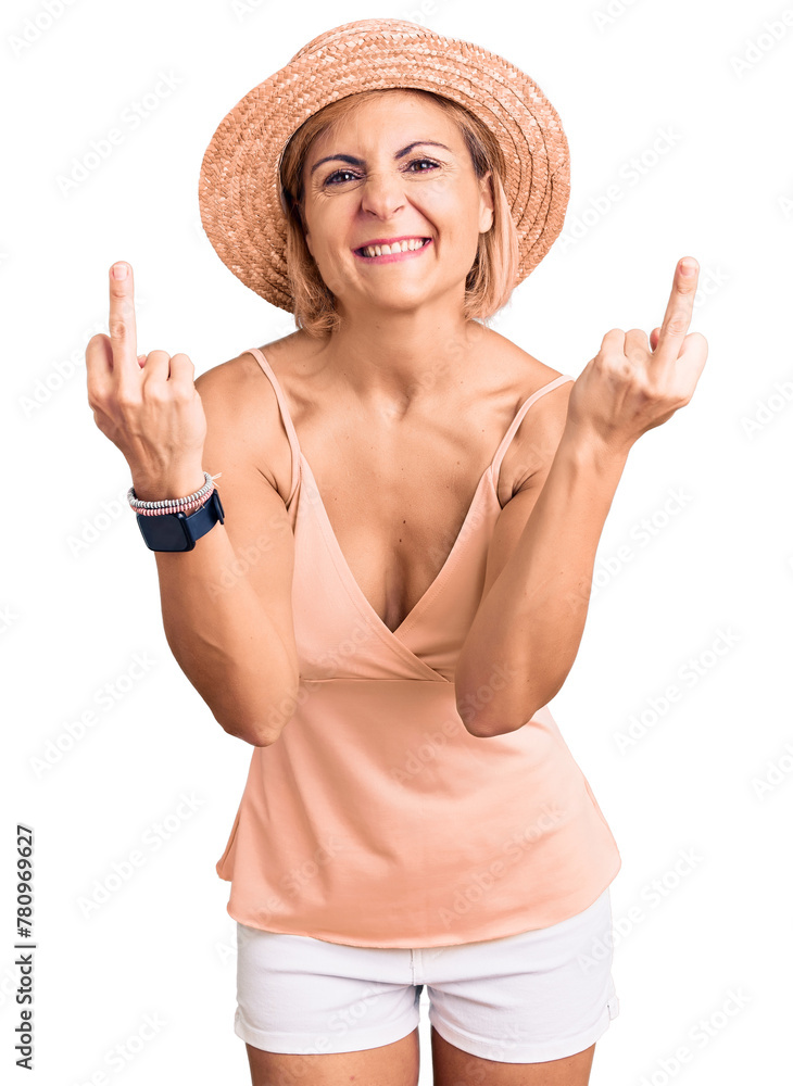 Young blonde woman wearing summer hat showing middle finger doing fuck you bad expression, provocation and rude attitude. screaming excited Young blonde woman wearing summer hat showing middle finger doing fuck you bad expression, provocation and rude attitude. screaming excited