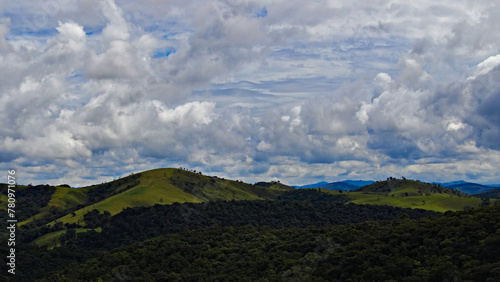 Serra da Bocaina mountains on the horizon, under a dramatic sky covered by dark clouds.
