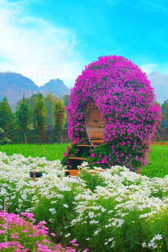 Quiet seat inside pink flower arch in garden