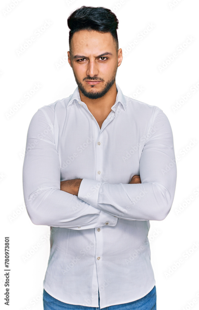 Young arab man wearing casual clothes skeptic and nervous, disapproving expression on face with crossed arms. negative person. Young arab man wearing casual clothes skeptic and nervous, disapproving expression on face with crossed arms. negative person.