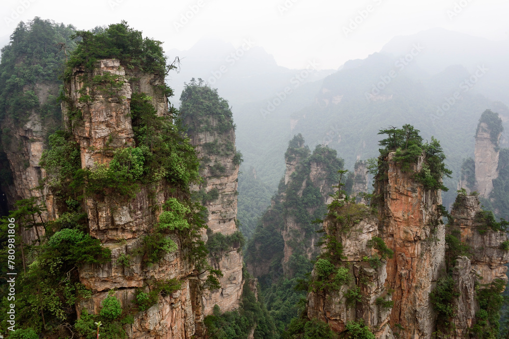 Sandstone pillars rise above the lush forest of Zhangjiajie National Forest Park in Wulingyuan Scenic Area, China.