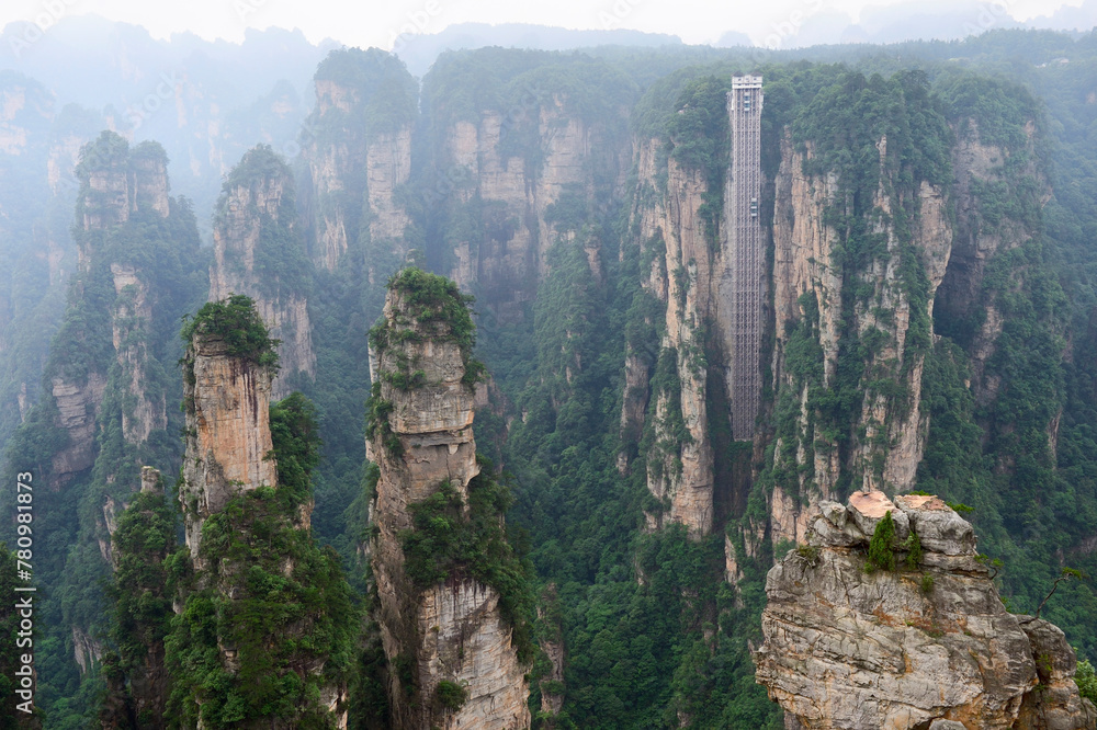 Sandstone pillars rise above the lush forest of Zhangjiajie National Forest Park in Wulingyuan Scenic Area, China.