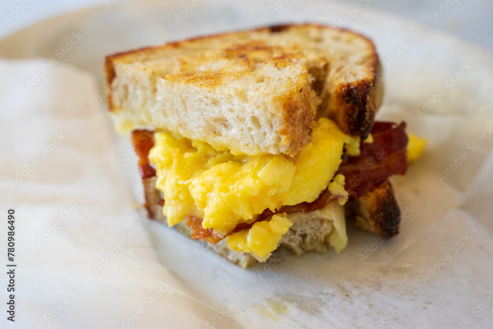 Sandwhich with scramble eggs and bacon. A typical breakfast or brunch in the US. The meal are also served with fried bacons and potatoes. Can also add sausages and butters. A very heavy breakfast. Sandwhich with scramble eggs and bacon. A typical breakfast or brunch in the US. The meal are also served with fried bacons and potatoes. Can also add sausages and butters. A very heavy breakfast.