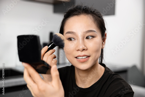 Confident Young Woman Holding A Makeup Brush, Capturing Feminine Charm And Self-Care. Perfect For Lifestyle And Fashion Themes