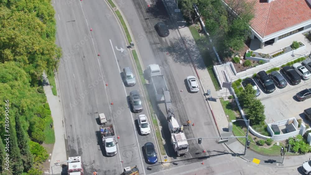 Aerial urban scene of a city road undergoing paving with a construction crew and machinery on a sunny day. Footage 4K. Aerial urban scene of a city road undergoing paving with a construction crew and machinery on a sunny day. Footage 4K.