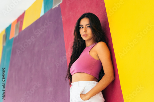 Portrait of a young latina woman. Colorful background © PEDROMERINO